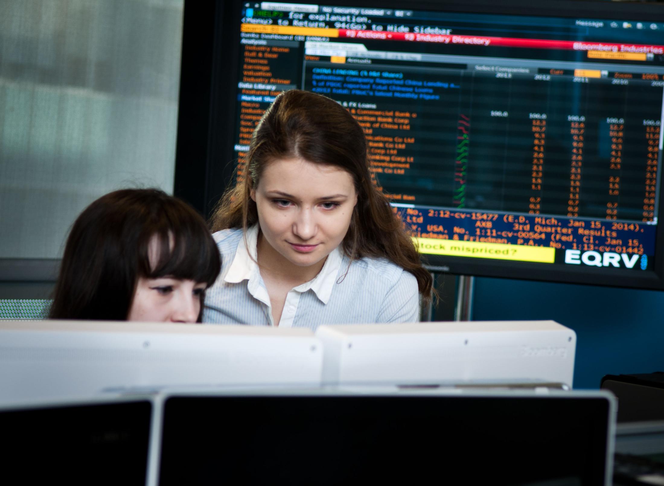 Two students working on a computer at the Financial Markets Lab