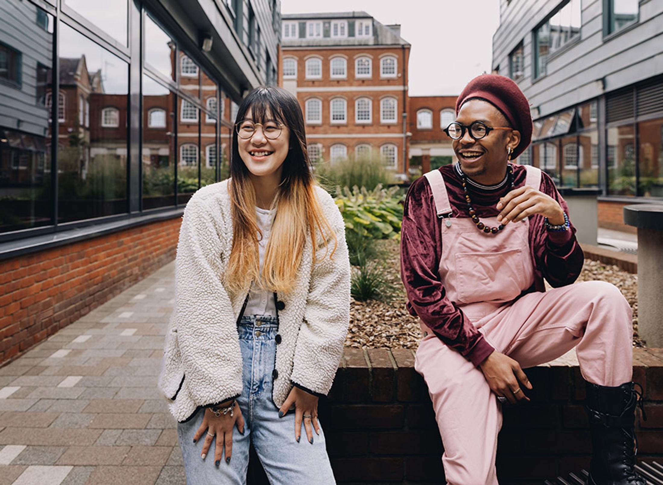 Two happy students posting together