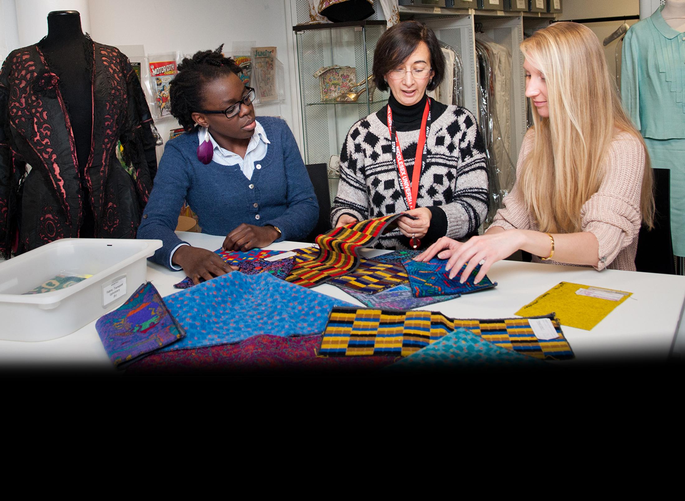 Two women examining fabrics