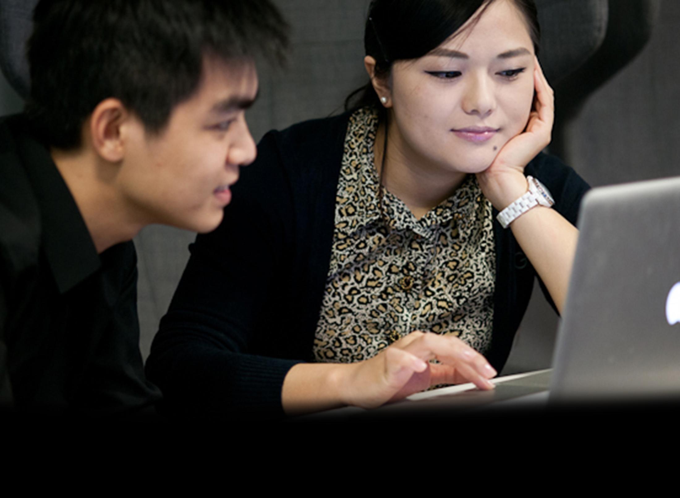Two students on a laptop