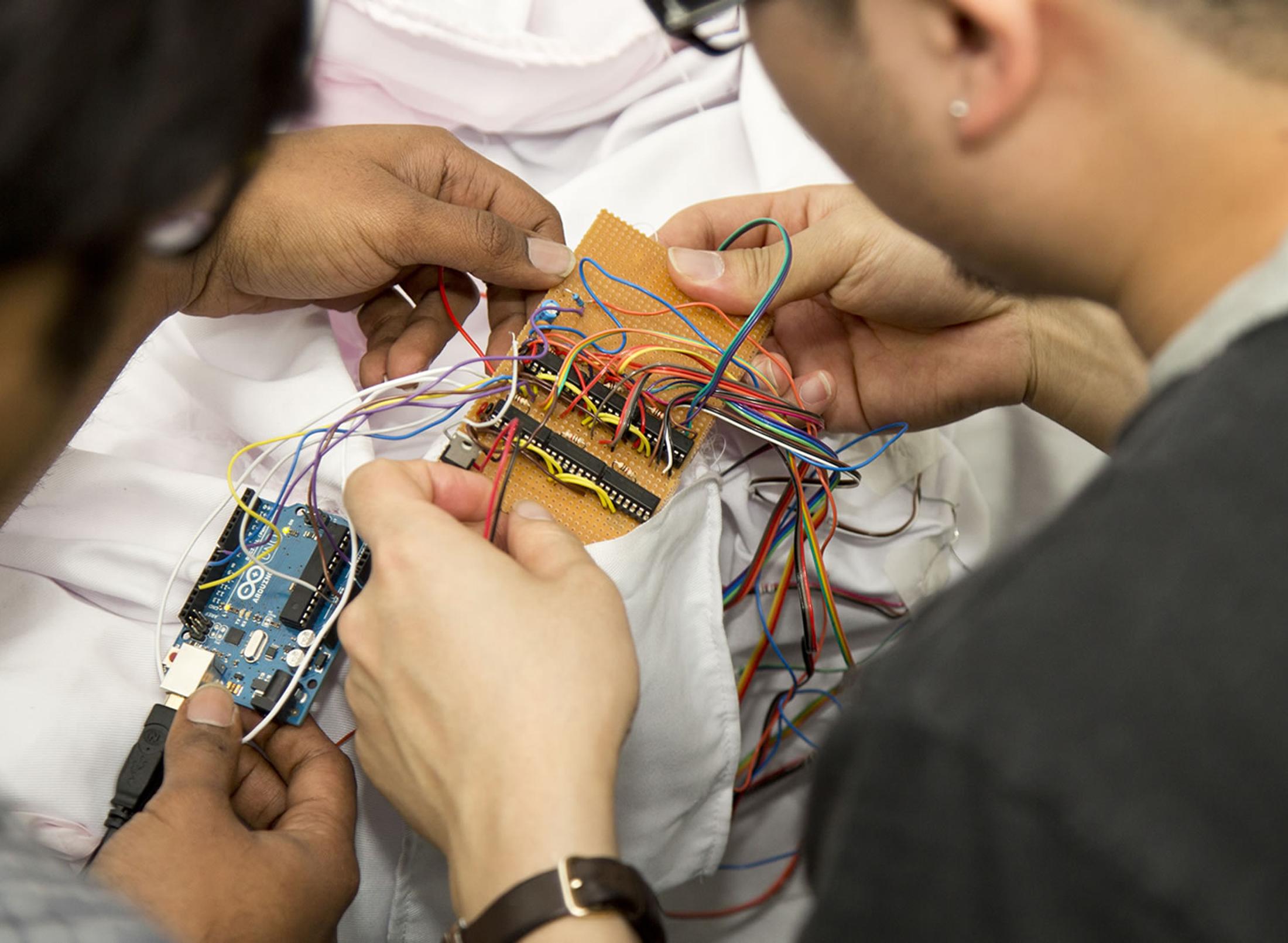 Students holding robotic equipment