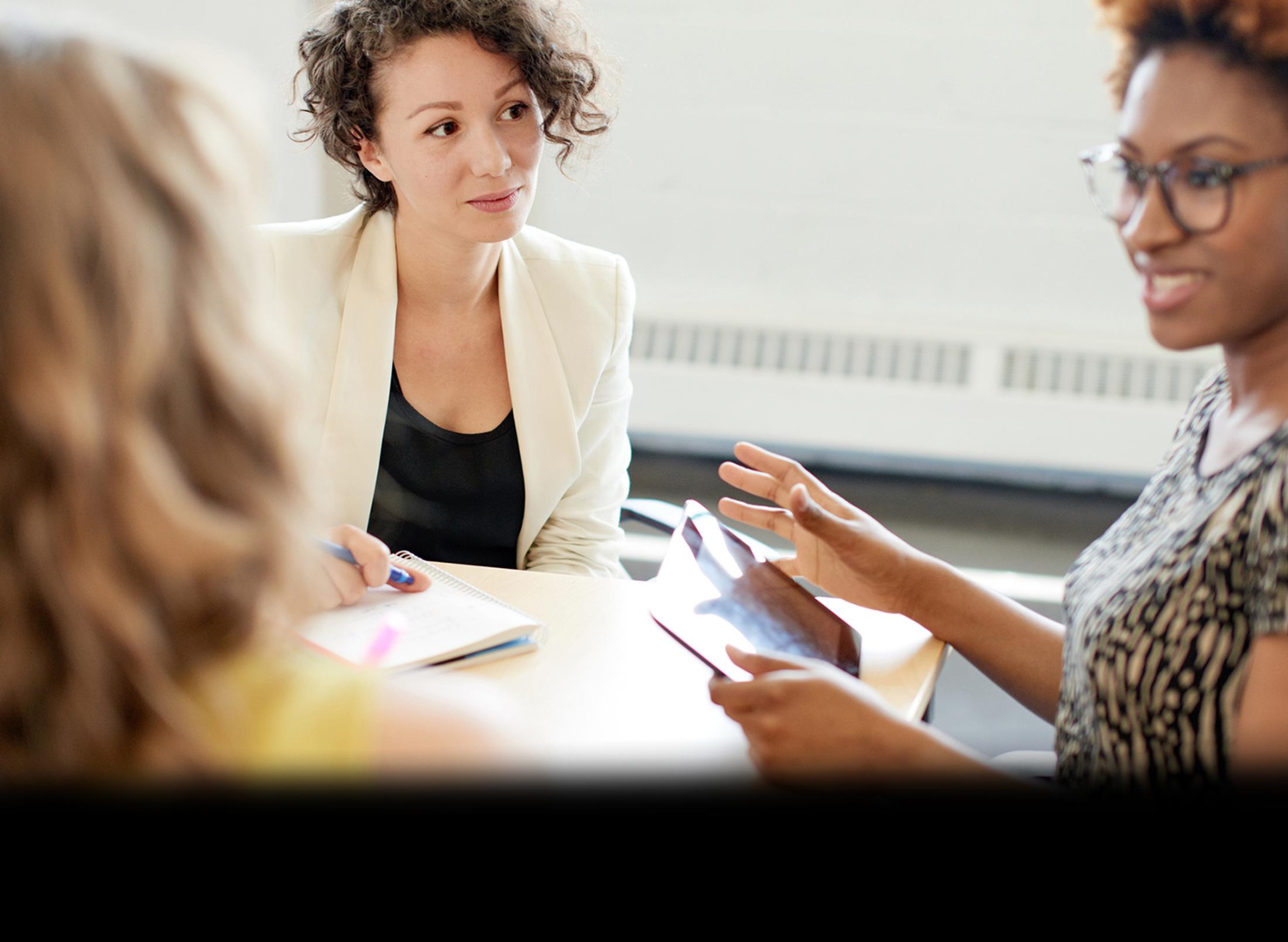 two woman facing each other in discussion