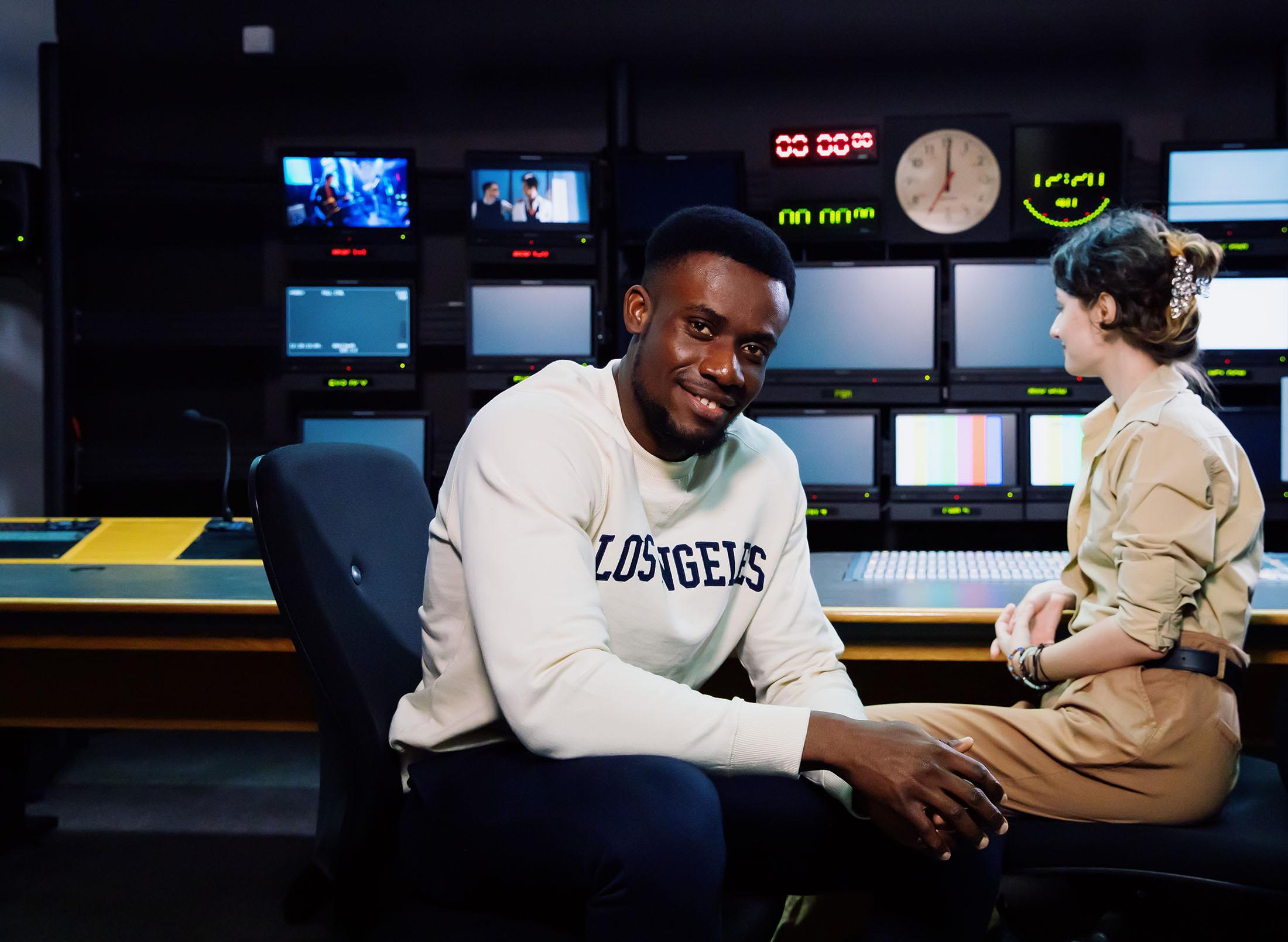 Two students sitting in TV studio