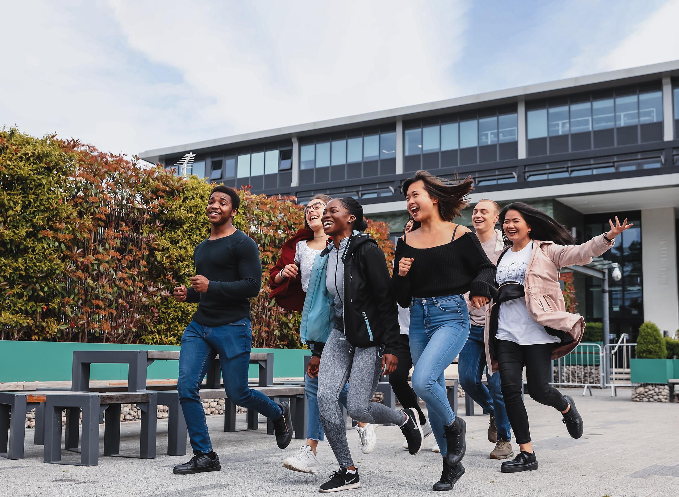 Group of students running and laughing