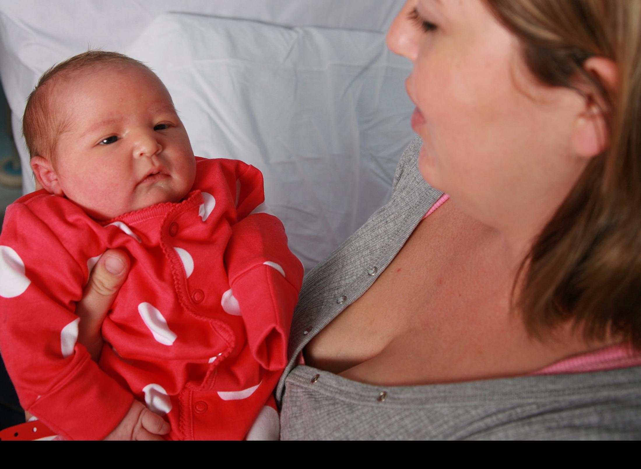 A woman holding a baby