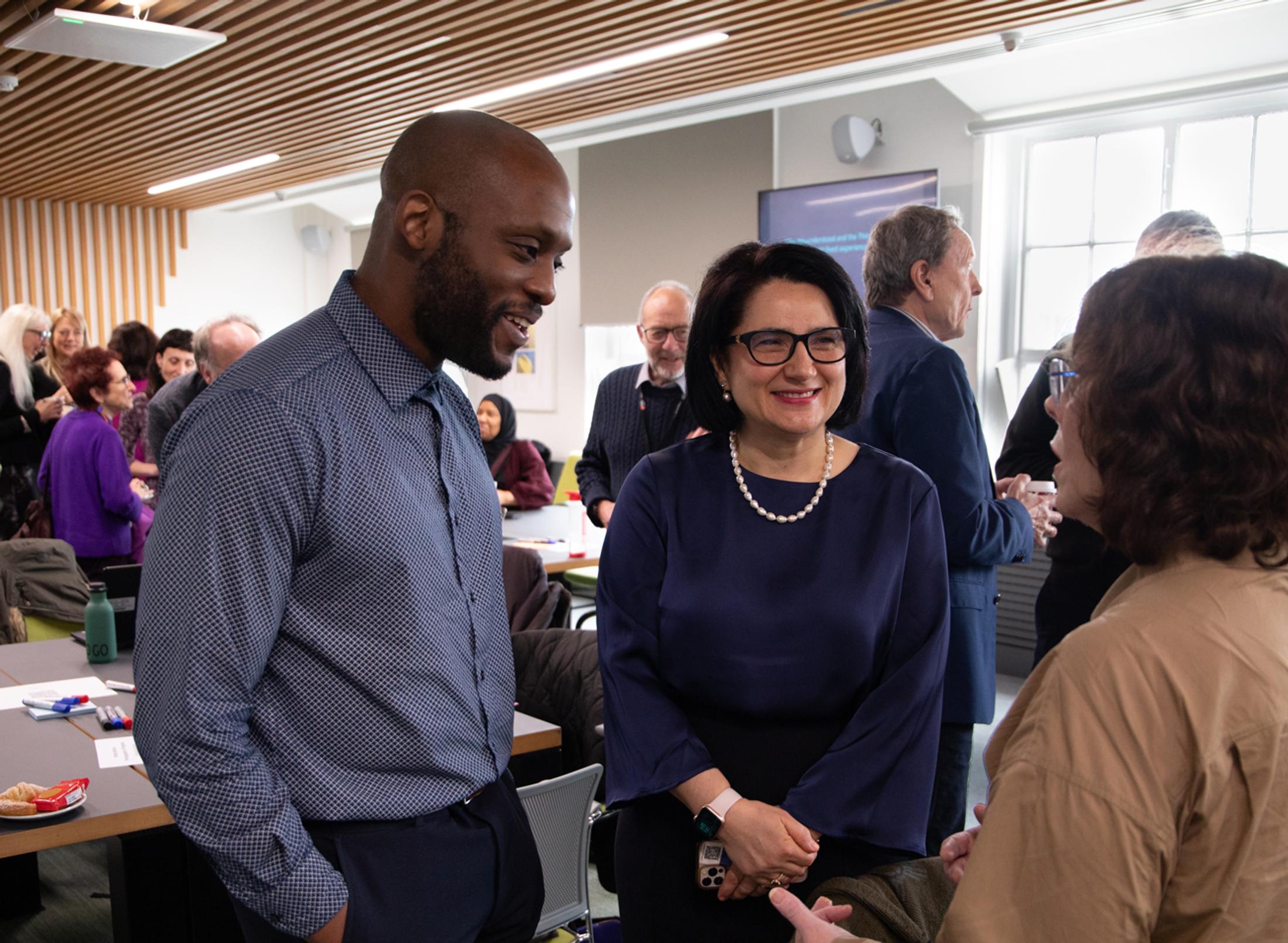 Adults having a friendly chat in a busy room