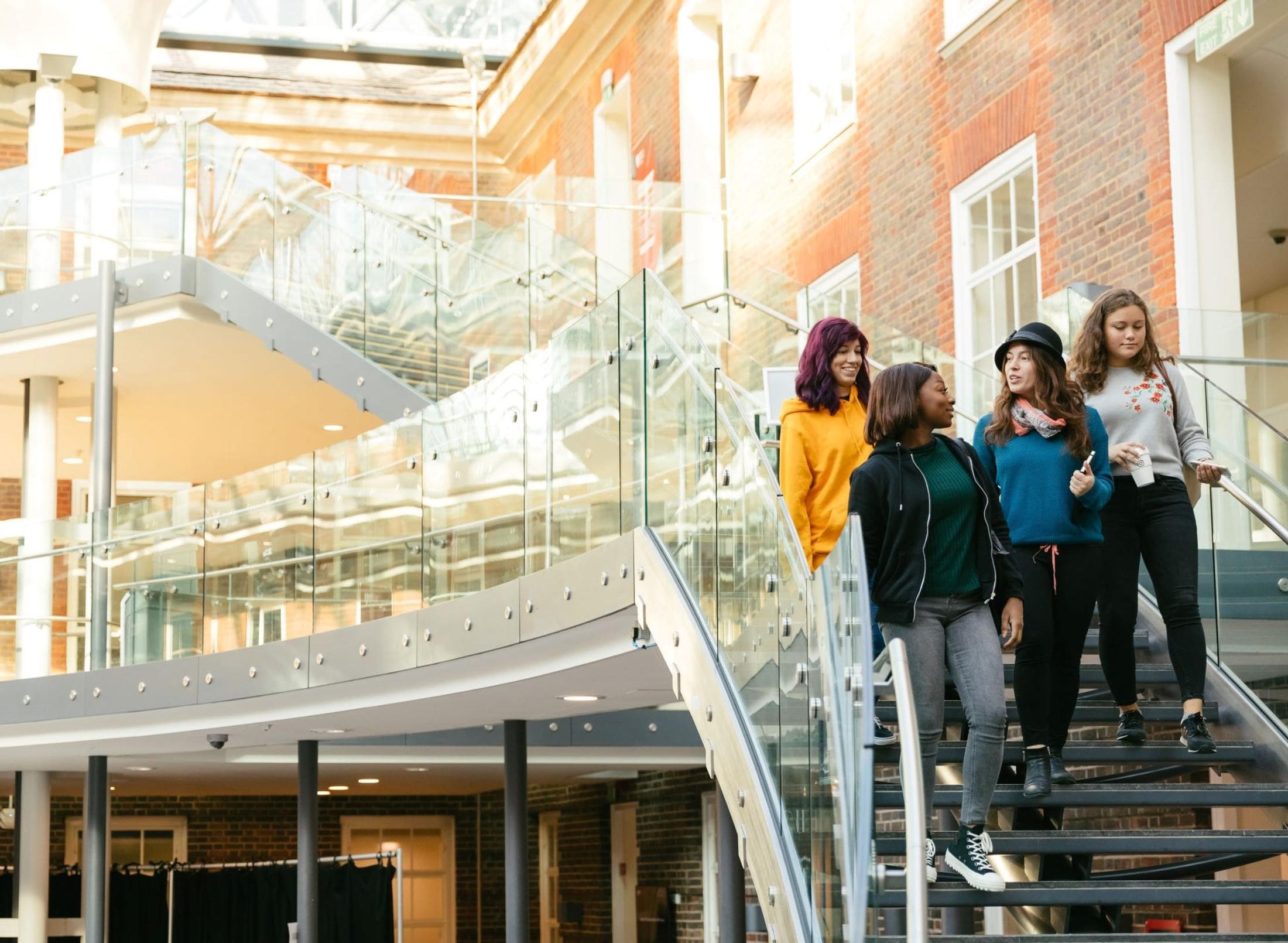 A group of students climbing stairs in a school building.