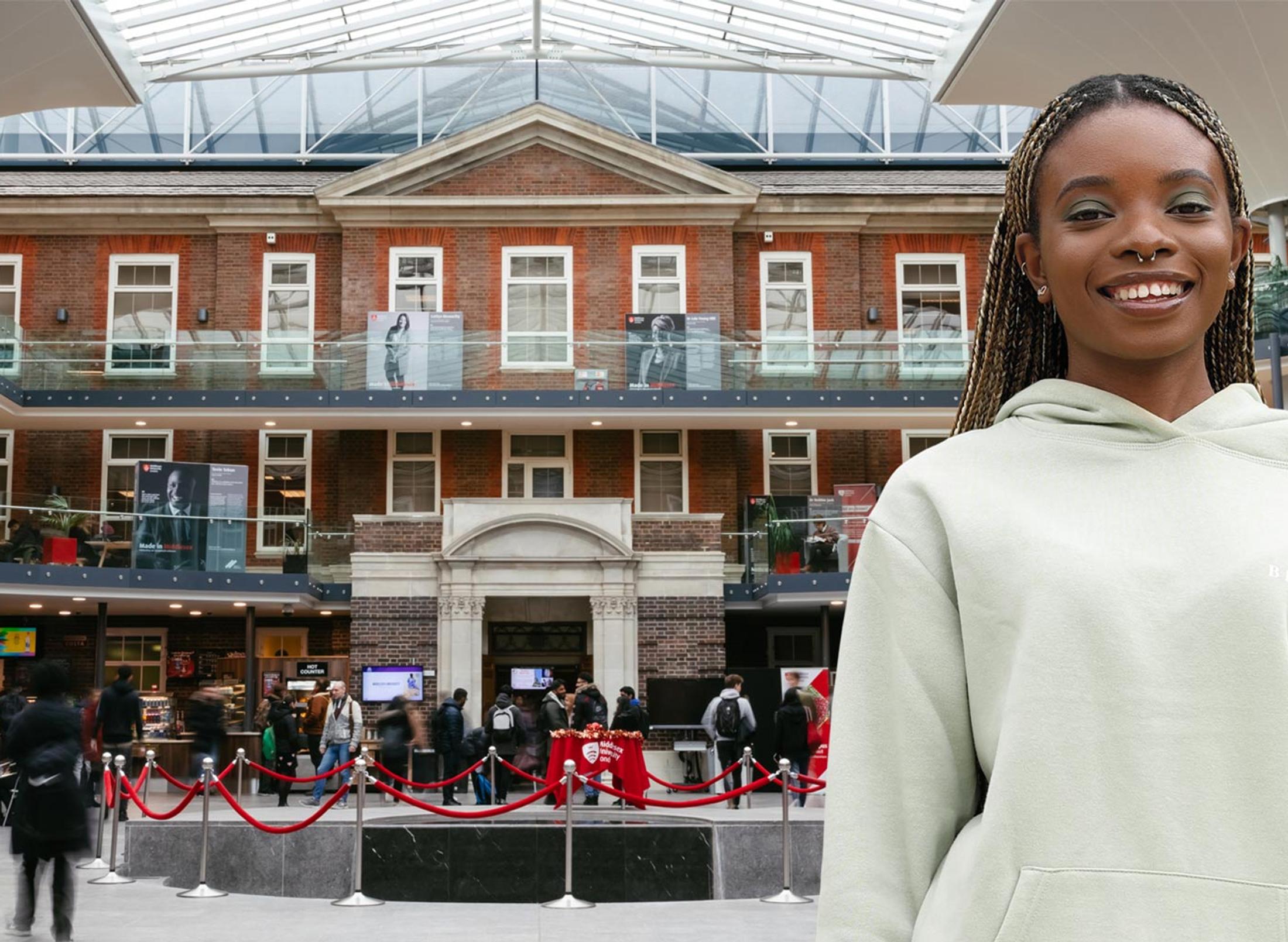 A woman in a white sweatshirt stands in a mall, surrounded by various stores and people.