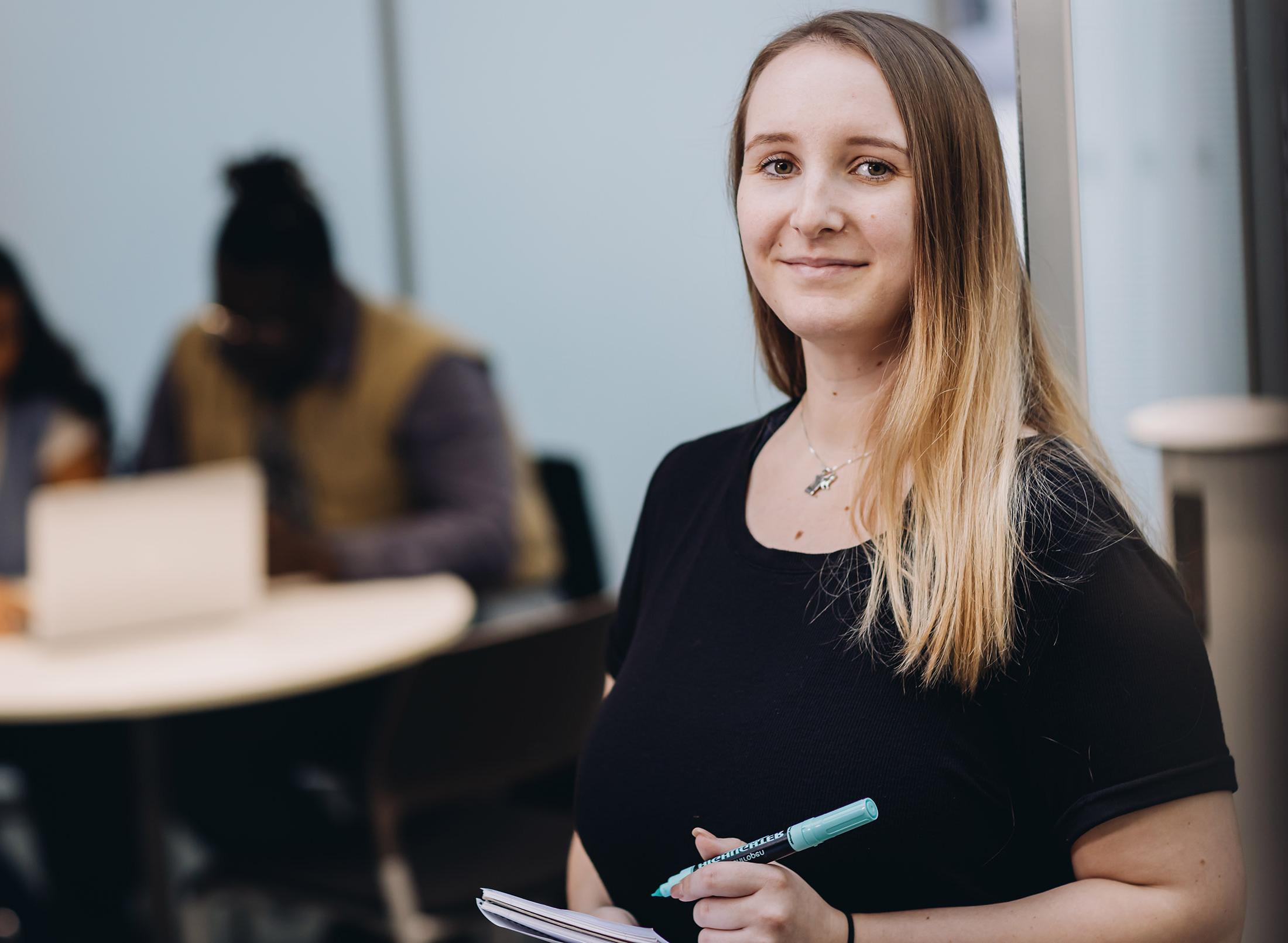 professional with clipboard in meeting room