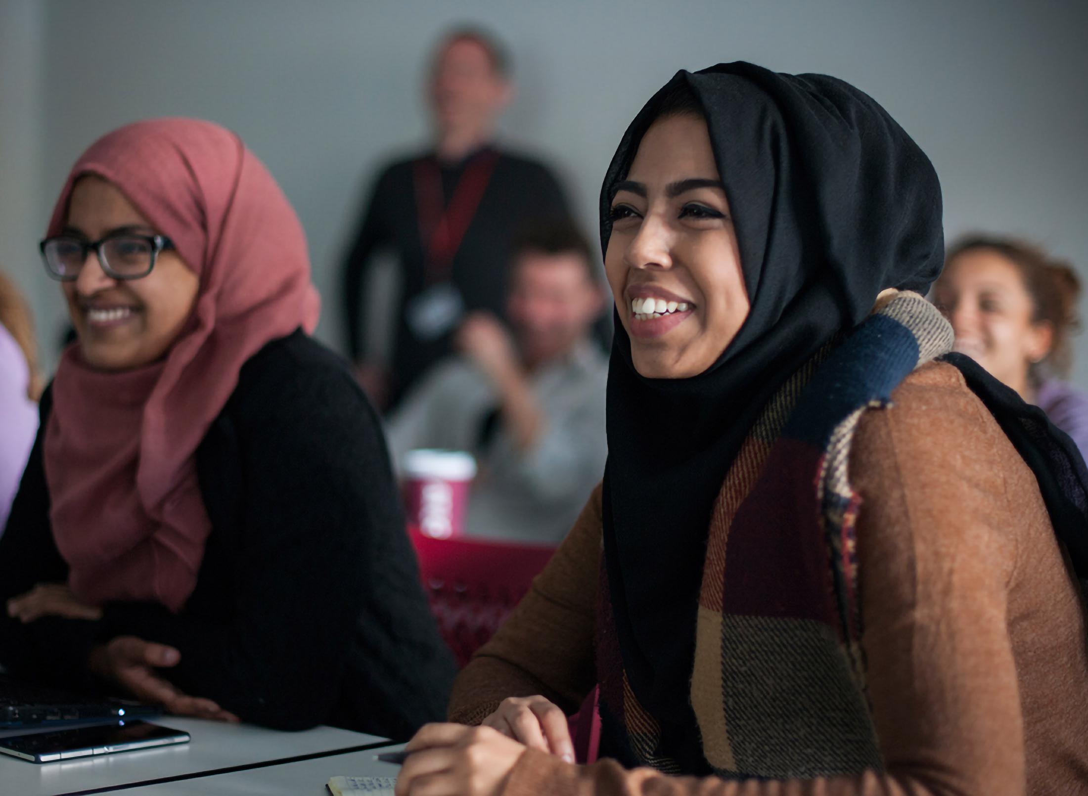 Students smiling in class, listening