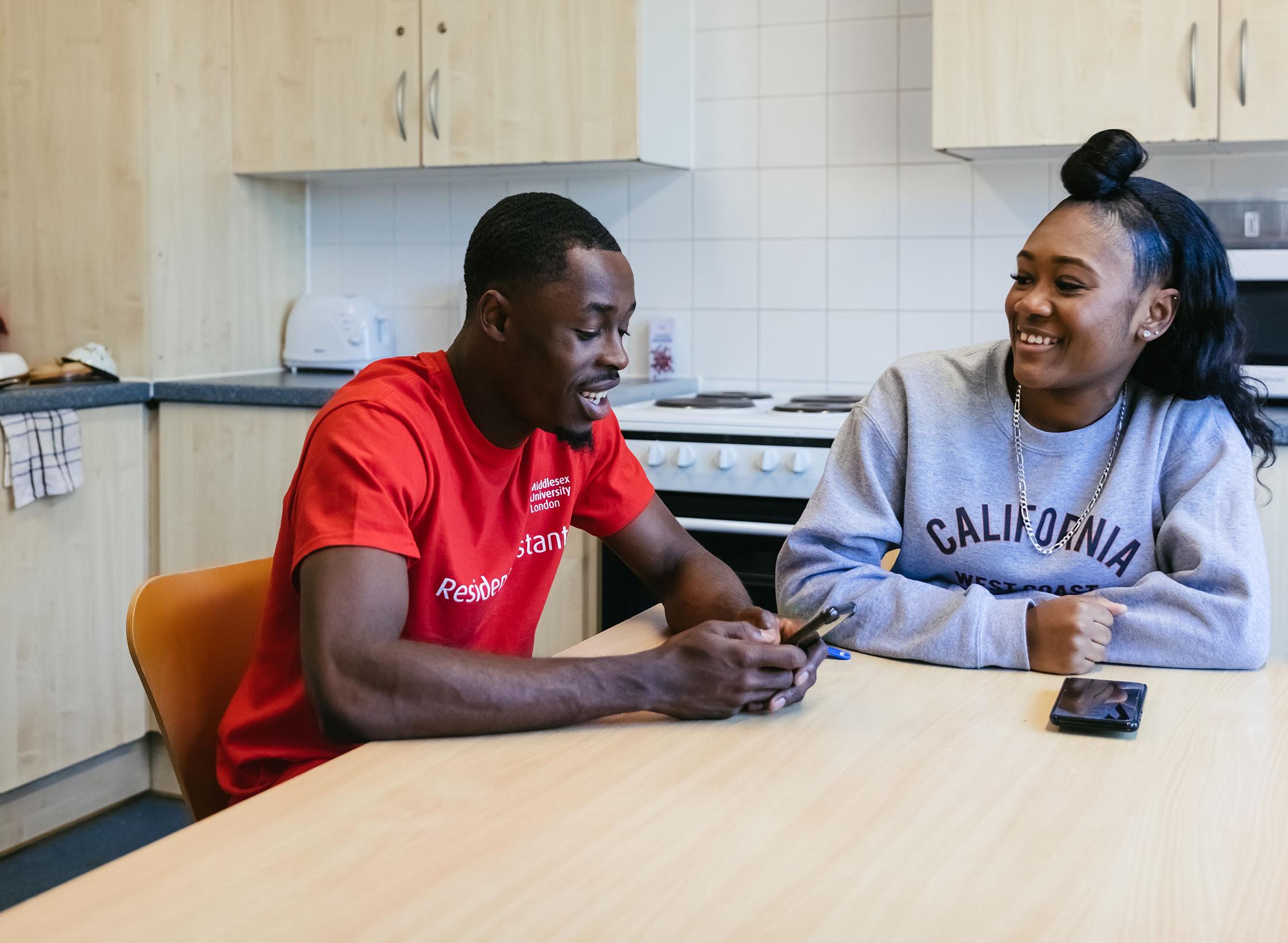students talking in kitchen