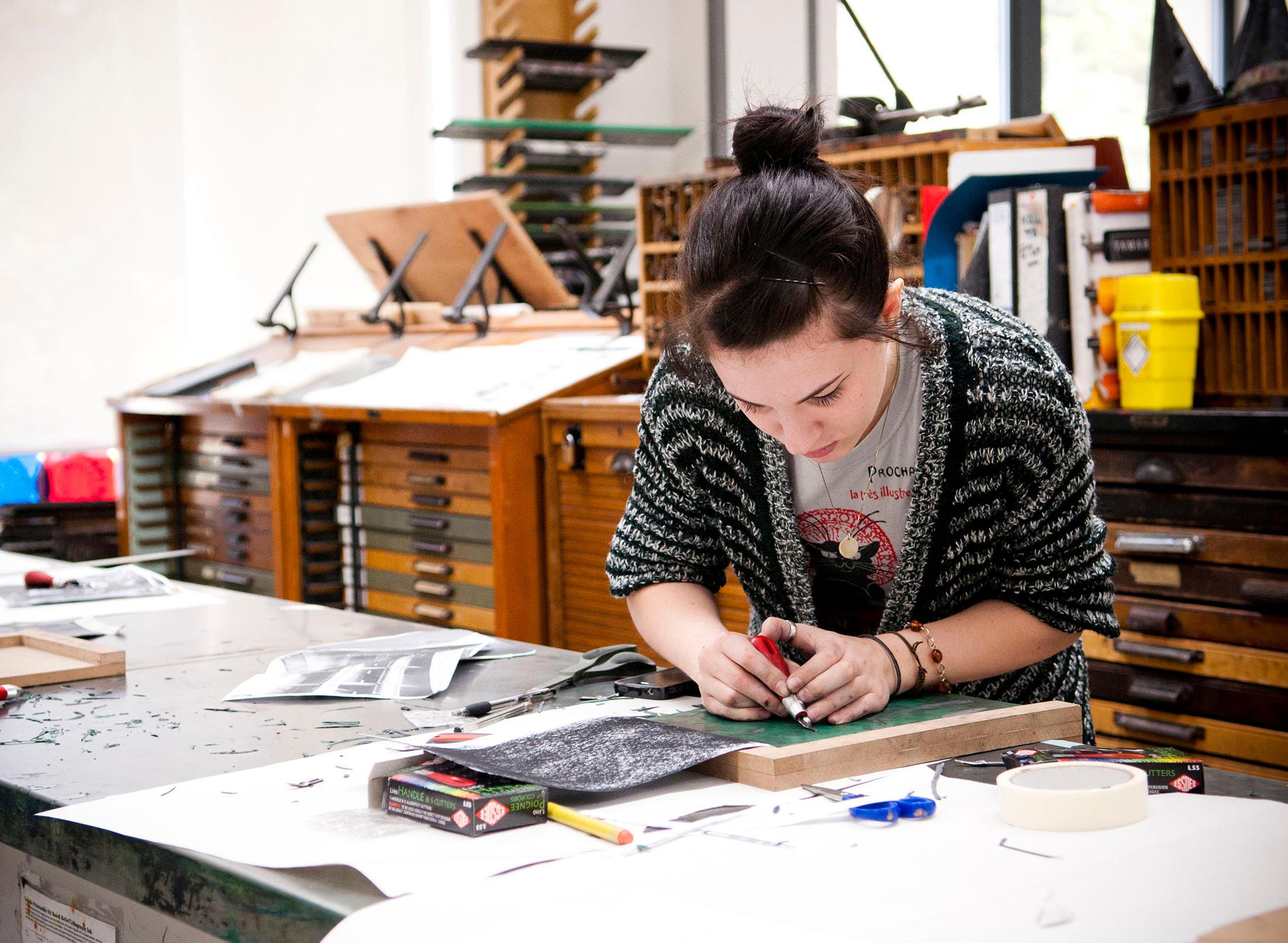 Student working on illustration in studio