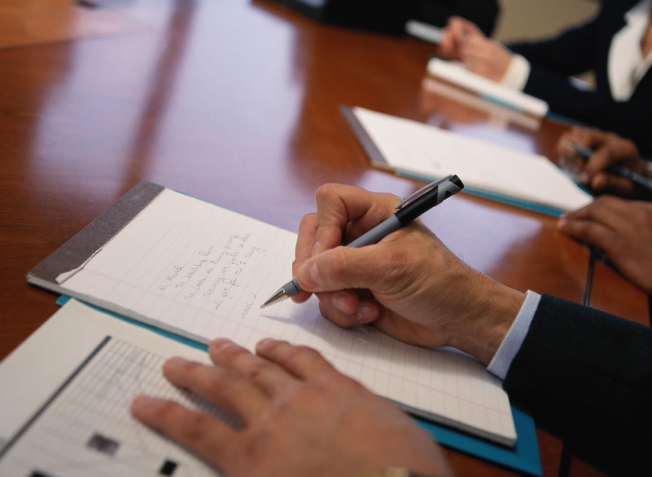 A student writing on a notepad