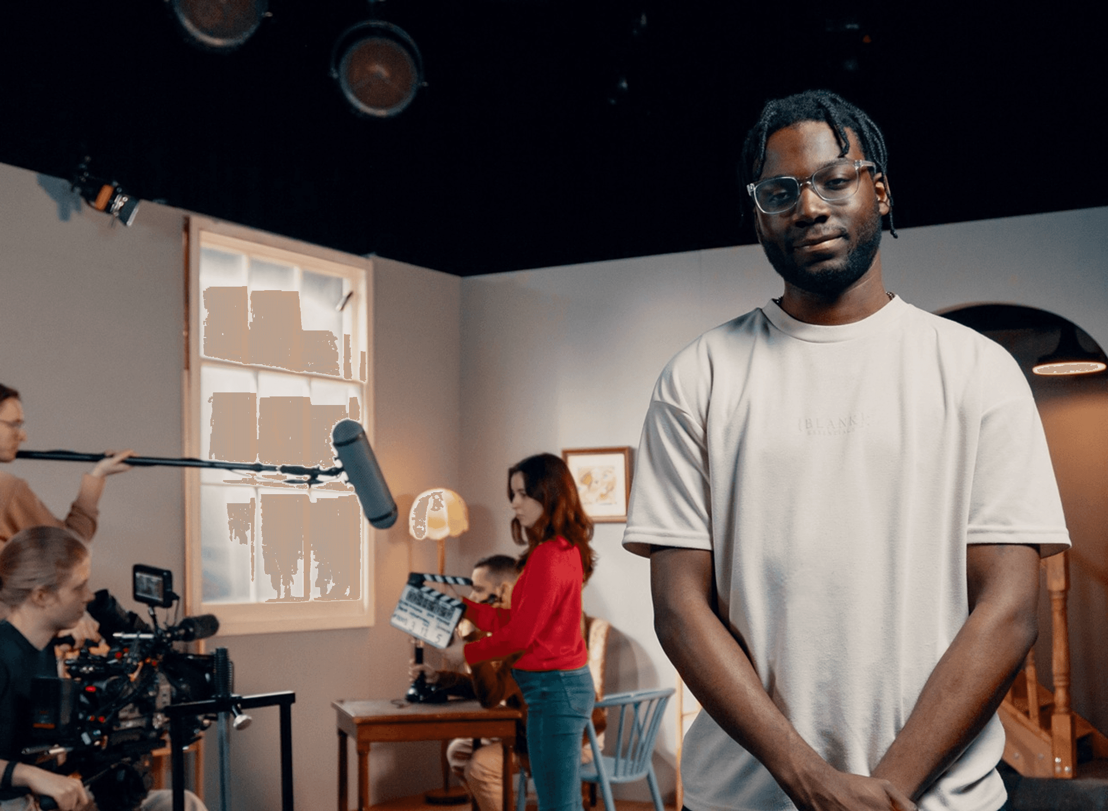 A man stands in front of a film production studio