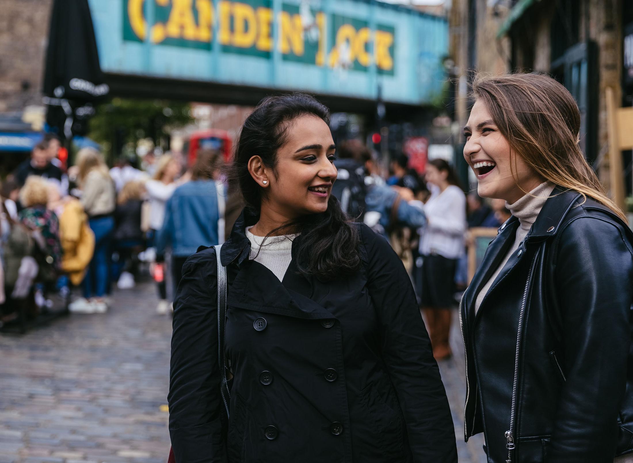 Two students in Camden market laughing