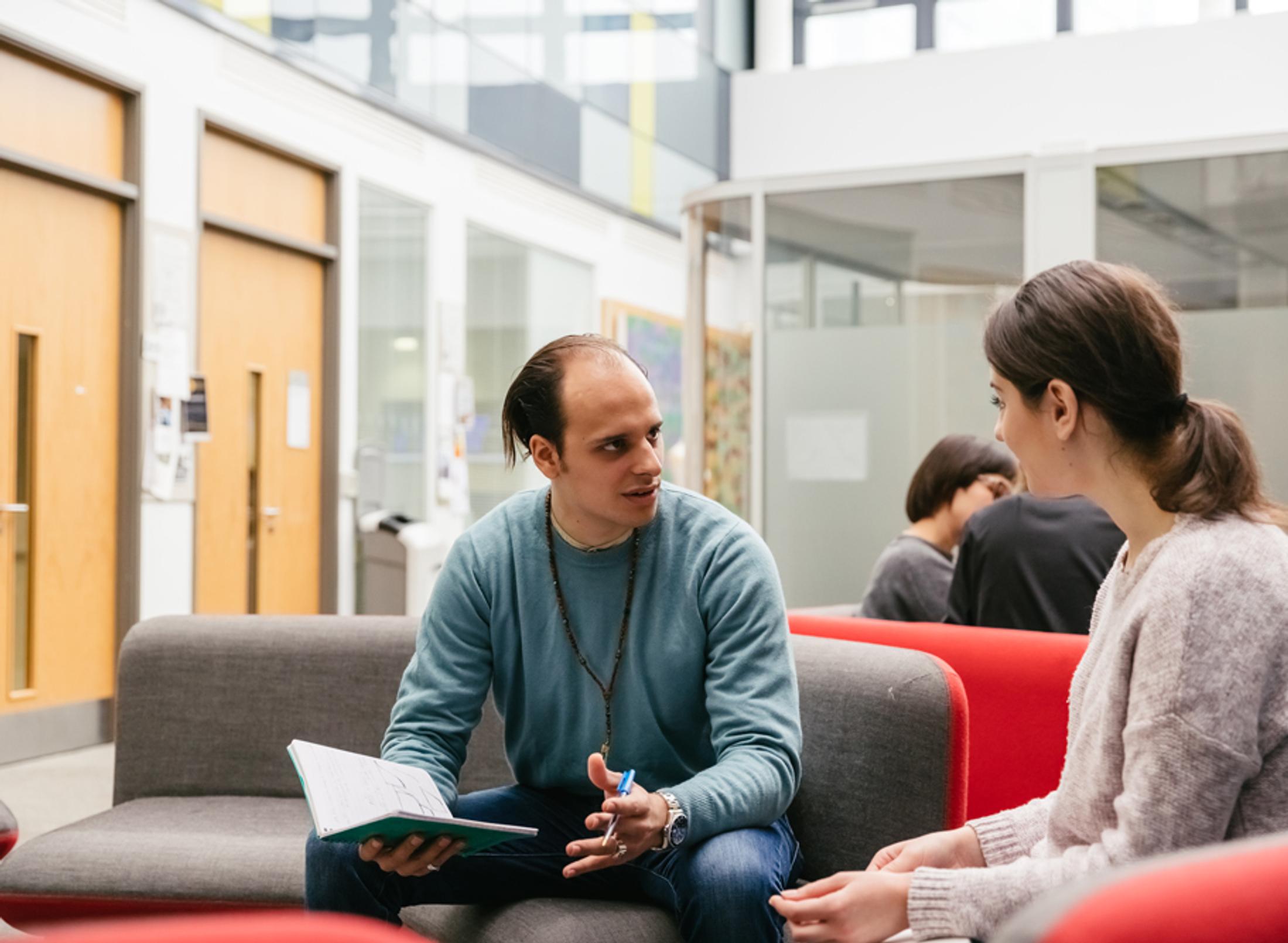 Two students talking on campus