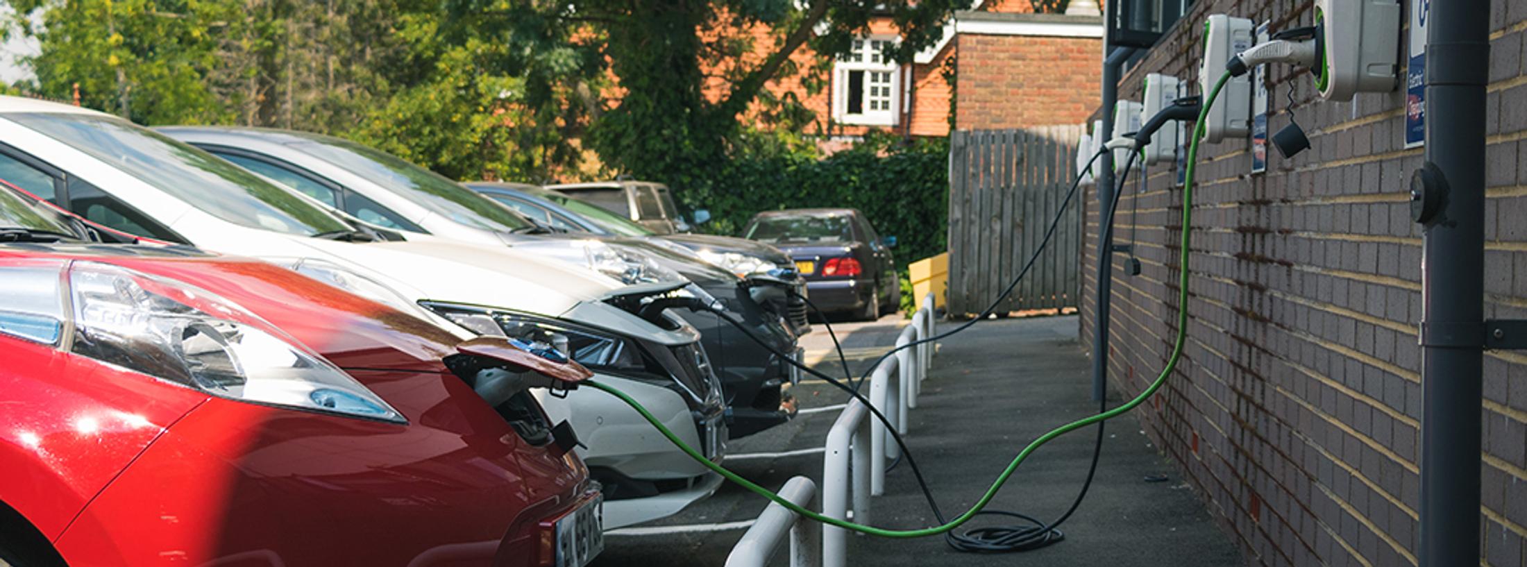 Electric cars charging at a station.