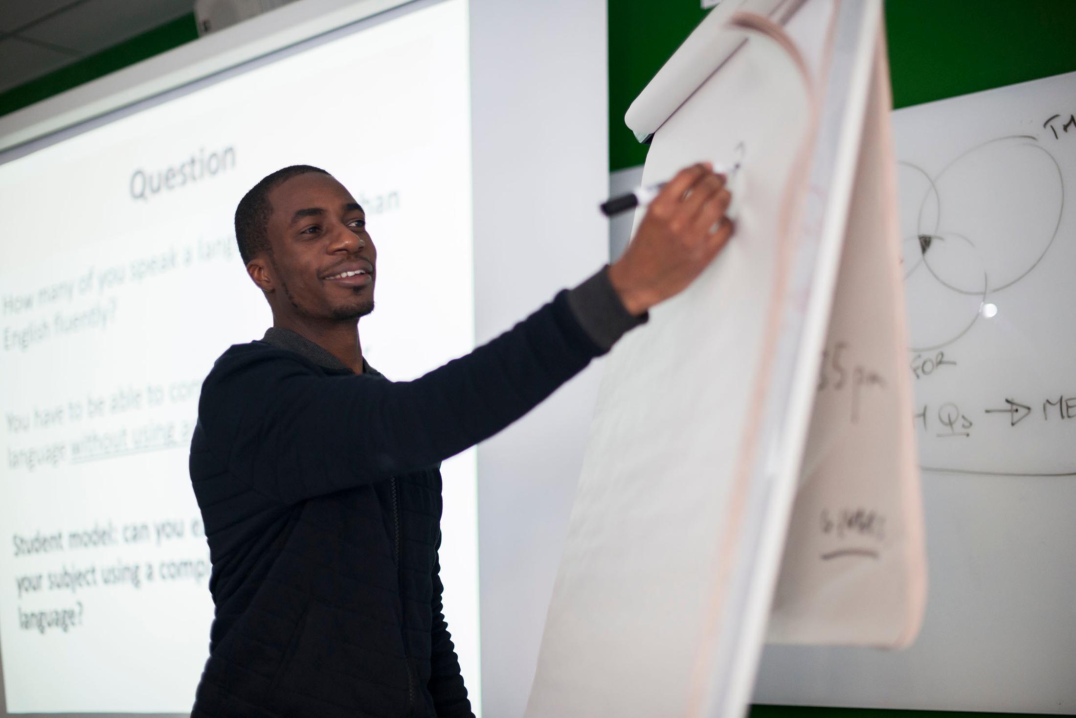 lecturer writes in large flipchart