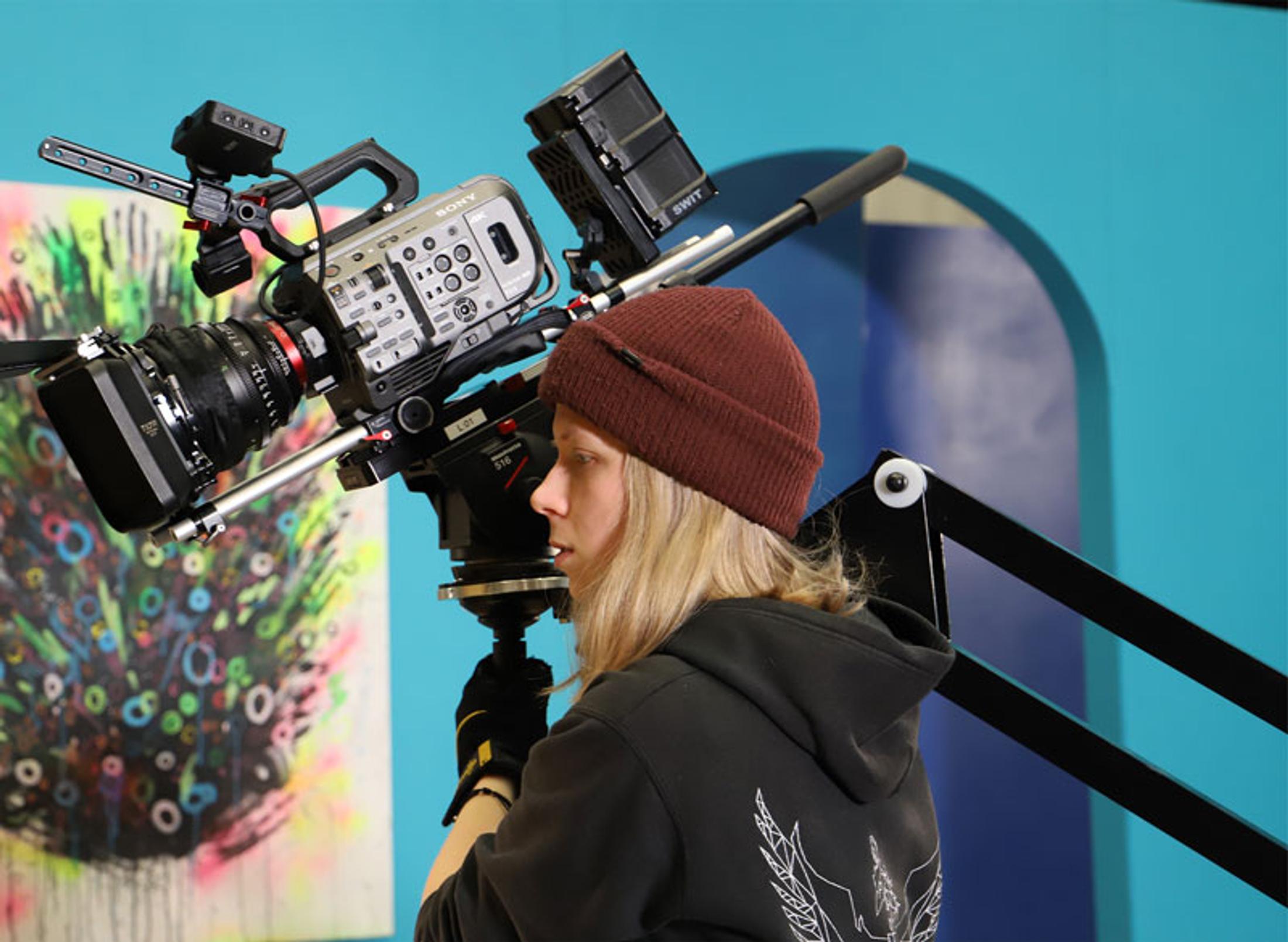 Student with a large video camera