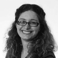 A black and white portrait of Dr Kelly Androutsopoulos