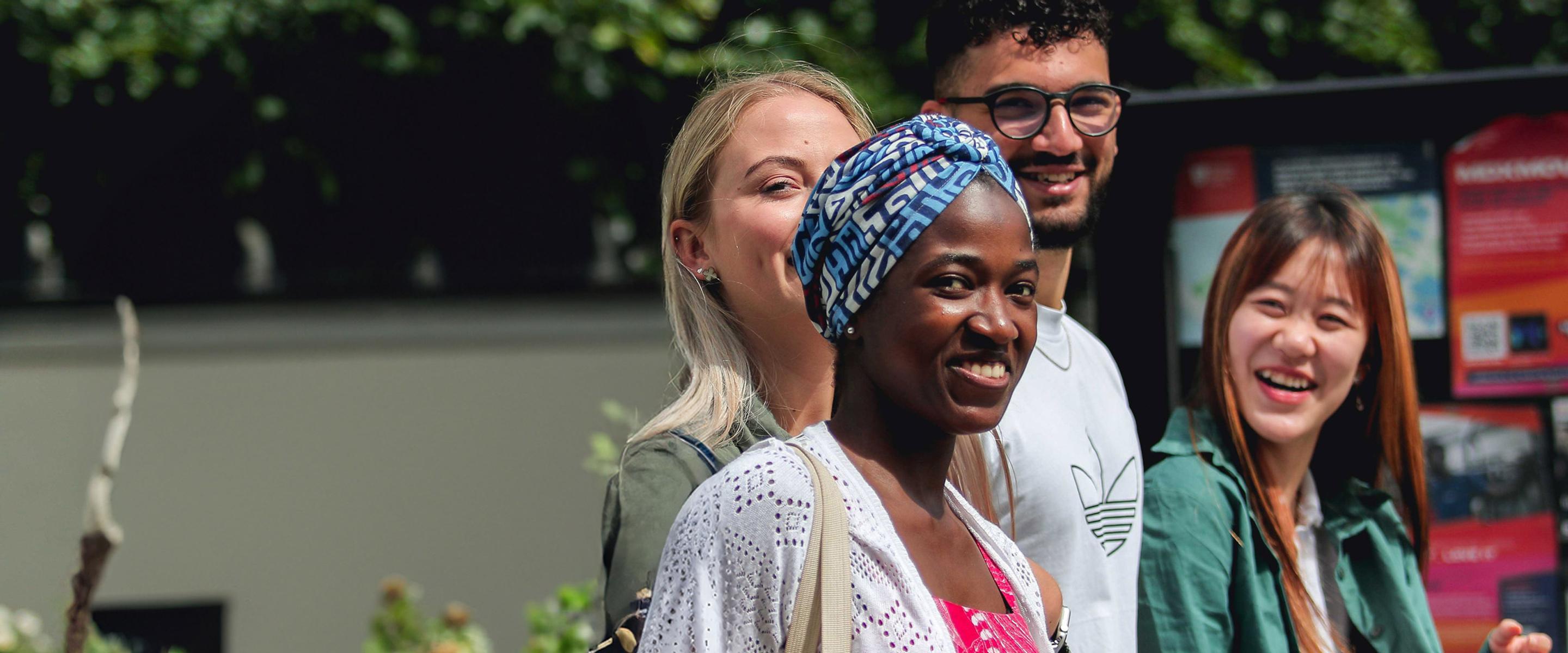 A group of international middlesex university students walk together outside