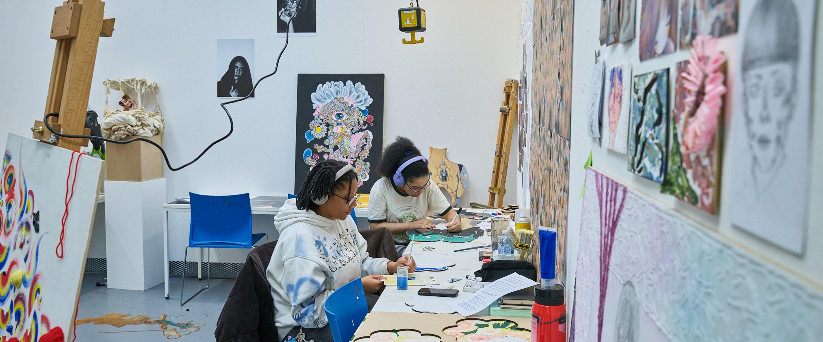 Two students working in art and design studio