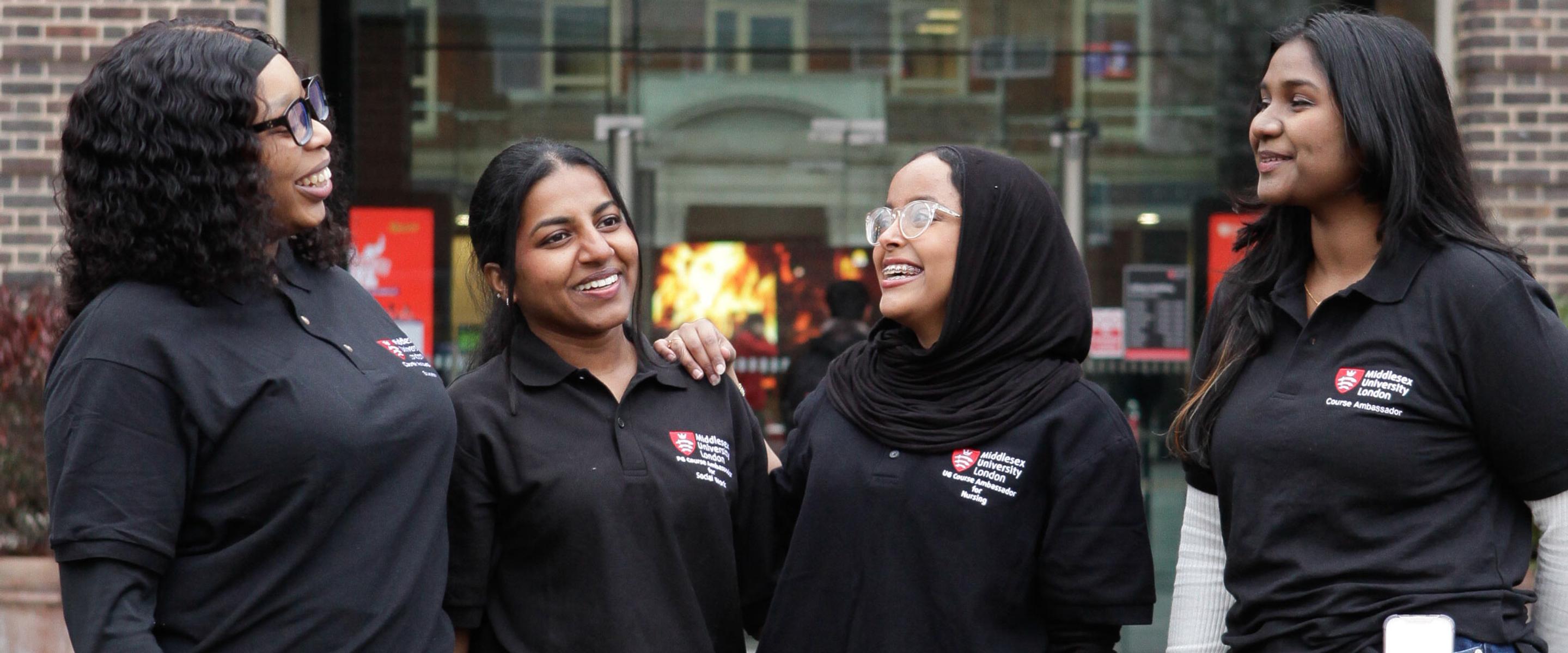 A group of 4 student ambassadors chatting outside campus