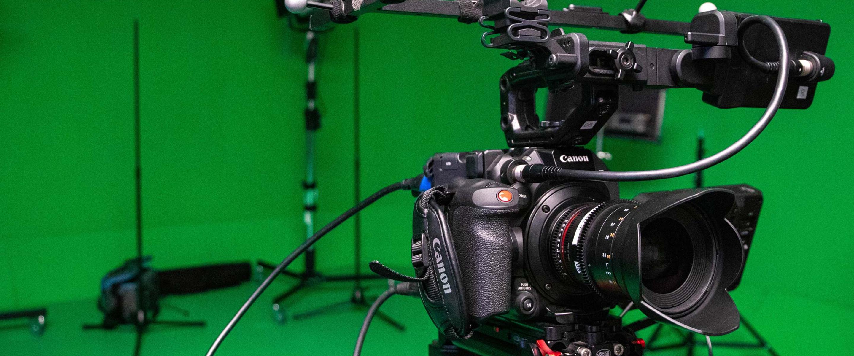 Close up of film camera with green screen background.