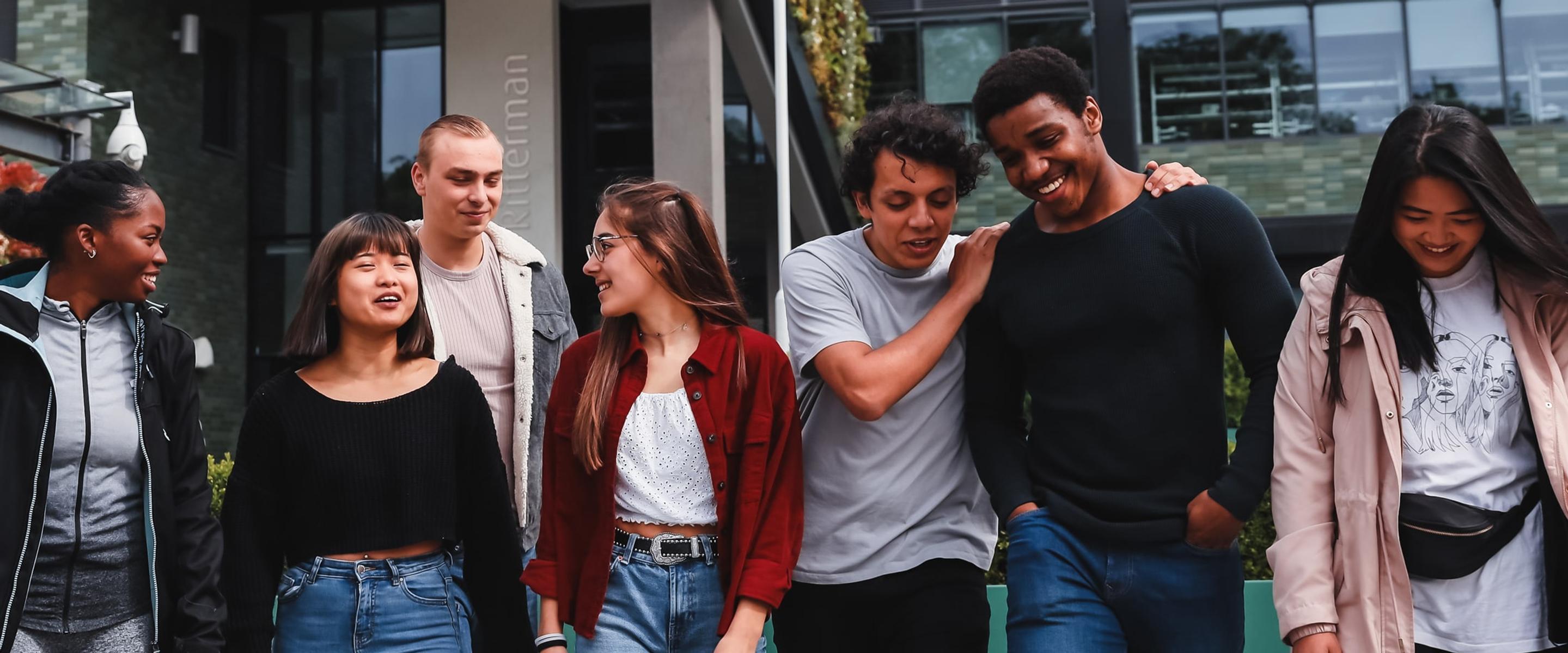 Group of students walking outside on campus.
