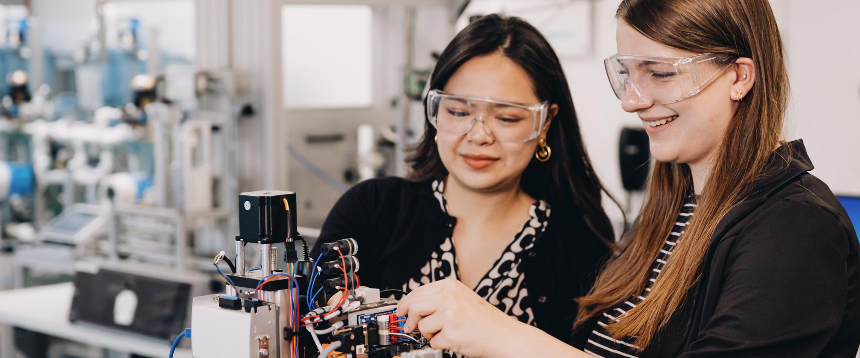 Two female engineering students working on a project.