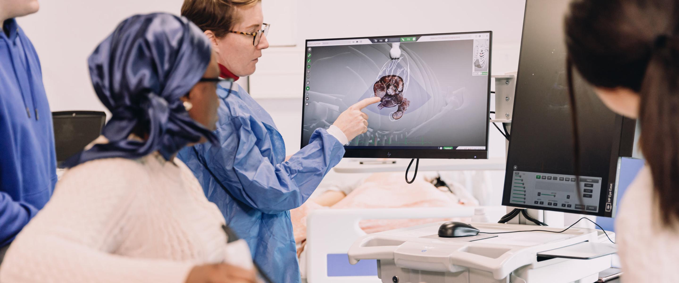 Students examining a patient scan.