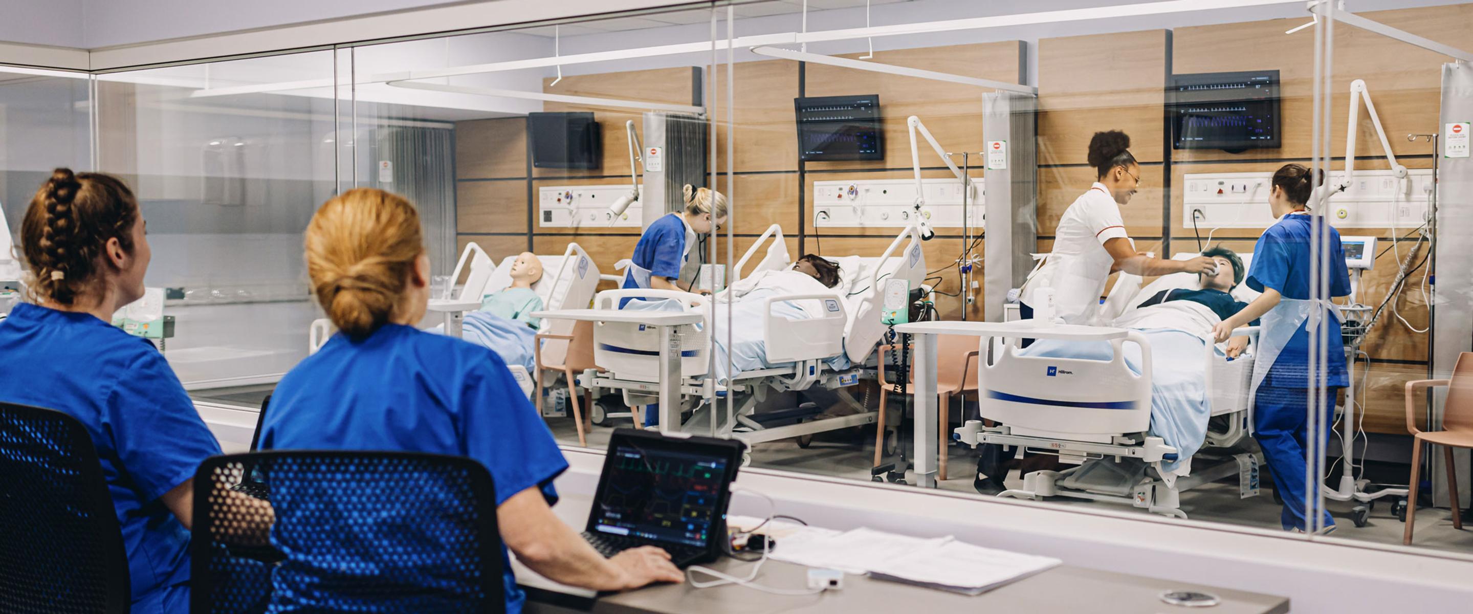 Students working in hospital ward simulation