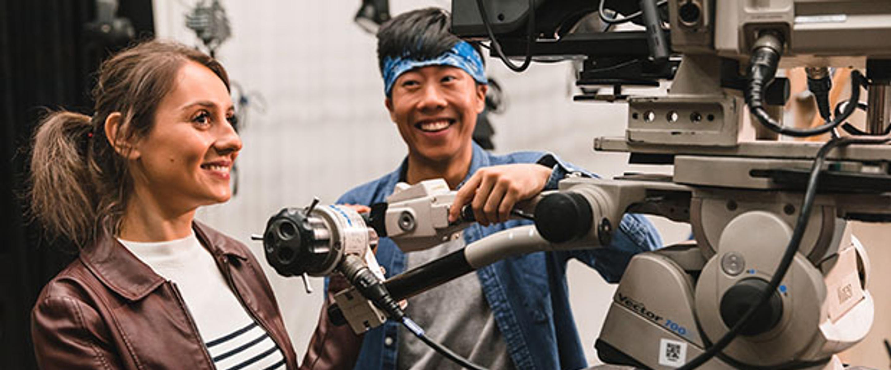 two students with large camera rig