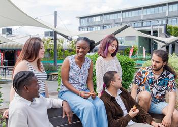Group of Middlesex students chatting on campus.