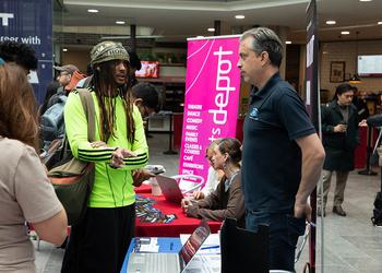 Students speaks with employer at university event