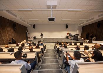 People sat in lecture theatre looking at a screen