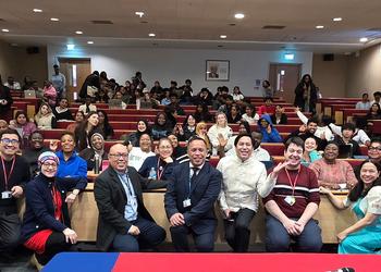 People look at the camera in a lecture theatre