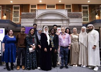 People from different faiths stood inside a university building