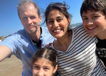 A family smile for the camera on the beach