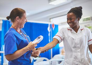 Nurses share a joke as they do a test on the ward