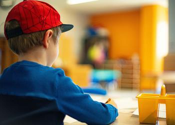 A young boy sat down doing work