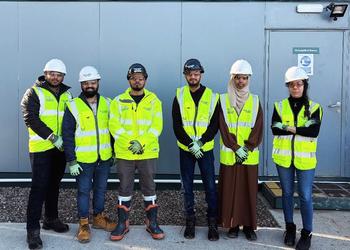 Students look at camera on a construction site