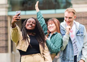 Three students on campus taking a selfie