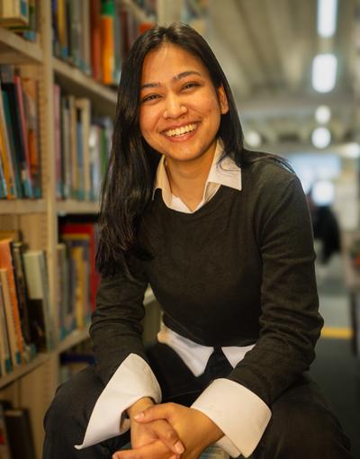 Student in library wearing a black top