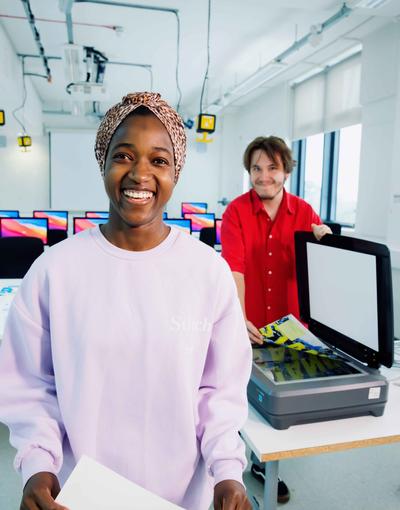 Two graphic design students working on a project