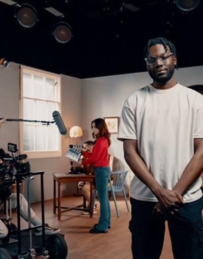 A man standing in front of a film set where a scene is being shot