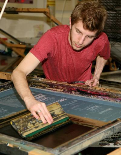 Student working on a print in the workshop