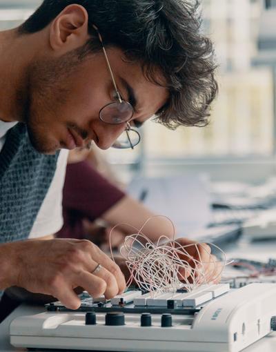 Computer science student working on a pcb
