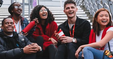 Group of students sits on steps