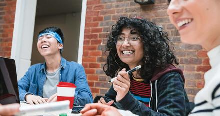 Student sat chatting in a study area